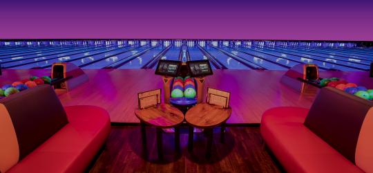 blacklight bowling lanes with plush couches