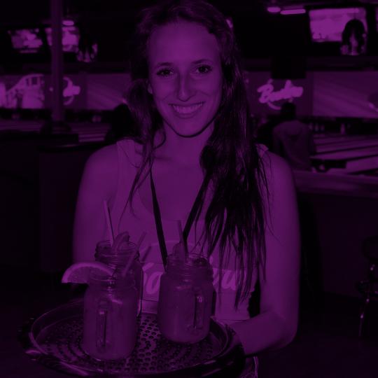 bartender holding a tray of cocktails