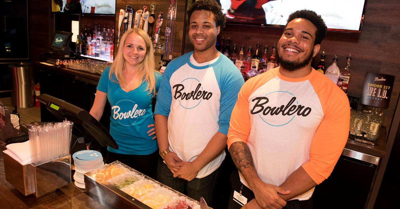 3 people smiling in Bowlero uniforms
